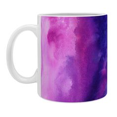 a purple and white coffee mug with watercolor paint on the inside, in front of a white background