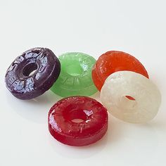 four different colored doughnuts sitting next to each other