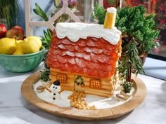 a cake shaped like a house on a plate