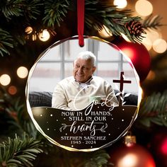 a christmas ornament with an image of a man on it and a cross in the background