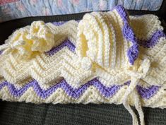 a crocheted blanket is laying on a couch