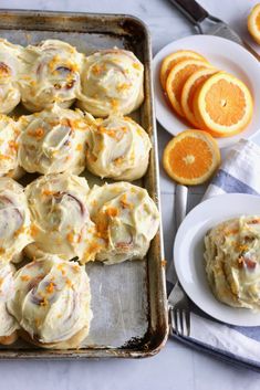 a pan filled with food next to orange slices