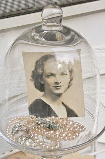 there is a glass case with pearls and a picture on it