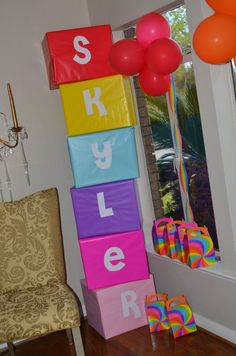 the room is decorated with colorful blocks and balloons