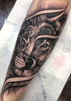 a black and white tattoo with a lion on it's arm, in the shape of a triangle