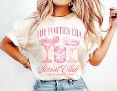 Celebrate your 40s in style with our fun and trendy "The Forties Era" Social Club Cocktail t-shirt! Perfect for a milestone birthday, this trendy tee is designed to capture the spirit of turning 40! DETAILS * Comfort Colors Garment-Dyed Heavyweight T-Shirt * 100% ring spun cotton * Design is printed using DTG technology which uses high-quality water-based inks that are printed directly into the fabric. This means that there may be a slightly faded/vintage look to the design depending on the color and fabric of the garment. SIZING * These unisex T-shirts are true-to-size with a relaxed fit. * Most women find their typical size works best since they are meant to be a bit loose fitting. * Some women size down for a tighter fit. * If you would like a more oversized look, we recommend sizing up 40th Birthday Outfits For Women, 30th Birthday Tshirt, 50th Birthday Tshirts, Bday Shirt, 21st Birthday Shirts, 40th Birthday Gifts For Women, 50th Birthday Gifts For Woman, 30th Birthday Shirts, 40th Birthday Shirts