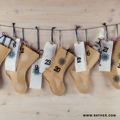 stockings hanging on a clothes line with numbers and snowflakes attached to the stocking