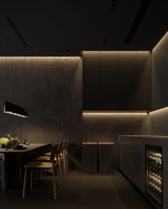 a dimly lit kitchen with an oven and dining table in the center, surrounded by chairs