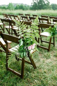 an outdoor ceremony with wooden chairs and flowers