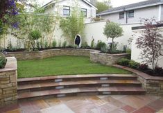 an outdoor garden with stone steps and grass