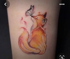 a watercolor tattoo of a fox with a butterfly on its nose