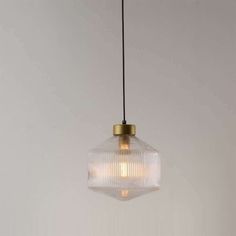 a glass light fixture hanging from a ceiling