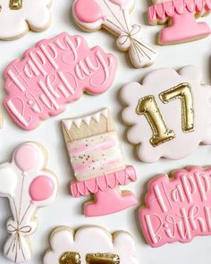 pink and white decorated cookies with gold foil numbers, balloons, and birthday cake on them