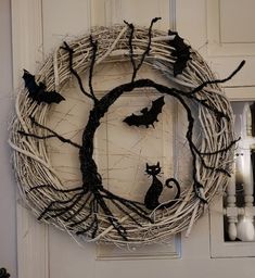 a halloween wreath with bats and a cat