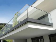 a modern house with glass balconies on the balcony