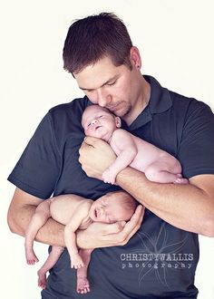 a man holding a baby in his arms