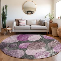 a living room with a white couch and purple rug