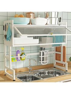 a kitchen sink with a shelf over it that holds dishes and utensils in front of the sink