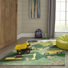 a child's room with toys on the floor and rugs in front of it