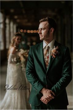 a man in a suit standing next to a woman