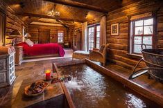 a room with a hot tub and bed in it