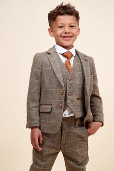 This heritage children's three-piece makes the perfect statement on the wedding day. Crafted with vintage inspired wool-mix cloth, it adopts a herringbone weave in earthy tones and works beautifully for country barn weddings. The multi-tonal check is synonymous with 19th century tweeds yet the colour pop accents give it that modern edge. Model wears size 5 yrs. Features Herringbone Single-breasted Notch lapel Single back vent Three button cuff Double button blazer fastening Complimentary pocket Fall Wedding Tweed Jacket, Wool Tweed Jacket For Fall Wedding, Fall Wedding Wool Tweed Jacket, Classic Brown Sets For Fall, Vintage Wedding Suits For Fall, Grandad Collar Shirt, English Gentleman, Country Barn Weddings