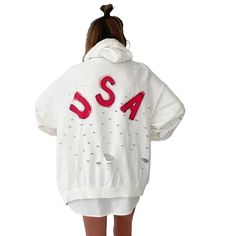 DESCRIPTION EACH PIECE IS MADE TO ORDER, HAND PAINTED BY GLORIA AND HER TEAM IN THEIR NYC STUDIO PRODUCT DESCRIPTION The perfect oversized white distressed hoodie. American flag painted on front chest, with USA painted on back in red, with blue outline. Signed @wrenandglory Due to each piece being hand painted, each piece might have slight differences. Limited edition. FIT Oversized, Super Comfy, Slouchy fit. Can be worn as a sweater or dress. One size fits most Measurements: Body Width 27", Len White Distressed Casual Sweatshirt, Oversized Distressed Long Sleeve Hoodie, Oversized Long Sleeve Distressed Hoodie, Oversized Distressed Hoodie For Fall, White Distressed Sweatshirt For Fall, Trendy Oversized Distressed Hoodie, Spring Distressed Long Sleeve Hoodie, White Distressed Long Sleeve Outerwear, Oversized Distressed Cotton Hoodie