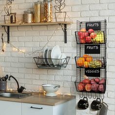 a kitchen with white brick walls and hanging fruit baskets