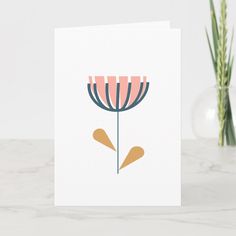 a card with a pink flower on it and two green plants in the back ground