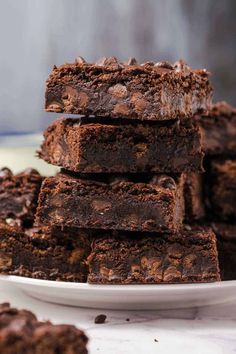 a stack of chocolate brownies on a white plate