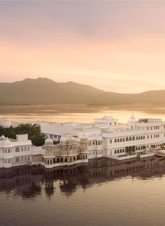 a large white building sitting on top of a body of water