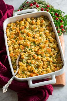 a casserole dish filled with stuffing and vegetables