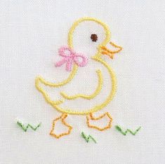 a close up of a small embroidered duck