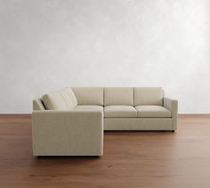 a white couch sitting on top of a wooden floor