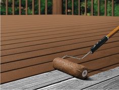 a paint roller on top of a wooden deck