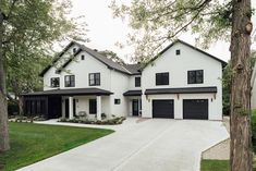 a large white house with black trim and windows