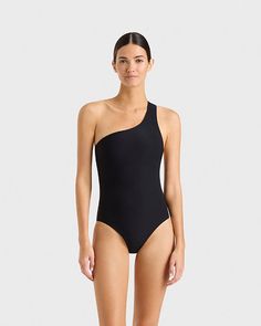 The Colette one shoulder swimsuit in Black is a signature Bondi Born style. Made using our unique Sculpteur® fabric with 3-D stretch, this elegant, classic one piece will never go out of style. Colette shapes the waistline and supports the bust with invisible under-bust support. The scooped out back adds a dramatic and sensual edge. This supportive and flattering piece suits cup sizes B to E. Luxury fabric sustainably made in Italy.Garment sustainably made in Australia. One Shoulder Swimsuit, Luxury Fabric, Cup Sizes, Out Back, Luxury Fabrics, Out Of Style, One Piece Swimsuit, Going Out, One Shoulder