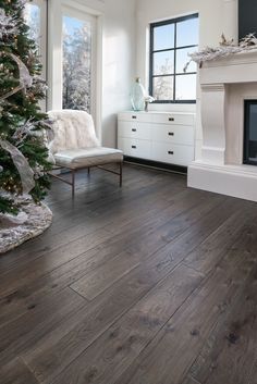 a living room with a christmas tree in the corner