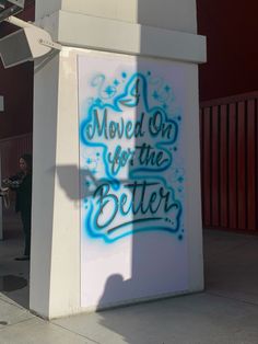 there is a sign that has been spray painted on the side of a building and it says move on for the better