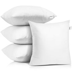 three pillows stacked on top of each other with the same pillow in front of them