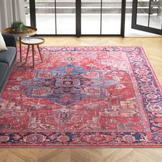 a living room area with a couch, coffee table and large rug on the floor