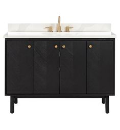 a black and white bathroom vanity with two gold faucets