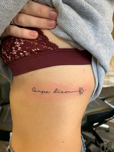 a woman's stomach with the words carpa diem and written in cursive font