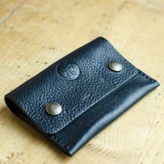 Black Leather Credit Card Wallet - Money Wallet - Leather Coin Pouch Finished with Waxed Thread and Antique Brass Stud. This small pouch has just one pocket with plenty of room to fit your cards, folded notes and cards. The simple design makes a great every day carry and will stand the test of time, looking great wherever you take it. Saddle stitched by hand with a burnished edge. Dimensions: W 110 mm H 70mm D 10mm Antique Brass Press Studs Handmade in Britain Handmade Black Trifold Wallet For Everyday Use, Handmade Black Pouch For Everyday Use, Everyday Handmade Black Pouch, Black Bifold Coin Purse For Everyday, Handmade Black Leather Coin Purse, Black Leather Handmade Coin Purse, Minimalist Black Trifold Wallet As Gift, Minimalist Black Trifold Wallet For Gift, Black Handmade Trifold Wallet For Daily Use