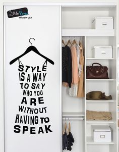 a white closet with clothes hanging on the wall and an open door that says style is a way to say who you are without having to speak