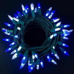 blue christmas lights are arranged in a circle on a black background with space for text