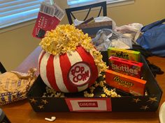 a box filled with popcorn sitting on top of a table