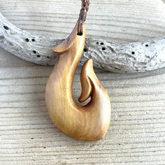 This is a large beautiful Hei Matau / Fish Hook pendant hand carved from genuine Indian sandalwood (Santalum Album). Material: Indian sandalwood (Santalum Album). Indian sandalwood (Santalum Album) is a small tropical tree, and the traditional source of sandalwood oil. It is native to southern India and Southeast Asia. Known as the 'king of woods', this precious species has a long and sacred history. For thousands of years, it has been used as a traditional medicine or to calm the mind with its Horn Ideas, Indian Sandalwood, Sandalwood Oil, Tropical Tree, La Source, Photo Box, Traditional Medicine, Iphone Camera, Jade Carving