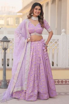 Step into a world of enchantment with this Lavender Viscose Jacquard Lehenga Choli, meticulously embroidered with sequins. The soft lavender shade exudes a dreamy and romantic vibe, while the lustrous sequins add a touch of glamour and sophistication. This trendy ensemble, paired with a coordinating dupatta, is perfect for modern festivities, engagements, and stylish social gatherings.                                                                Inquiry: Call/WhatsApp: +919820845150
Email: info@manthanfashion.com
#lehengacholi #indianwear #indianfashion Jacquard Lehenga, Sabyasachi Designer, Heavy Lehenga, Velvet Lehenga, Indian American, Wedding Party Wear, Jacquard Blouse