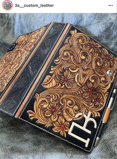 an intricately decorated leather book with writing on it